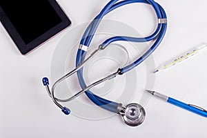 Stethoscope or phonendoscope, tablet and thermometer, medical device for auscultation, medical equipment on a white background