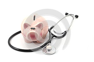 Stethoscope and piggy bank