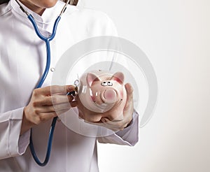 Stethoscope and piggy bank
