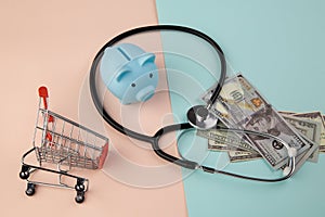 Stethoscope,piggy and money - a business concept in medicine