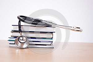 Stethoscope on pile of journals