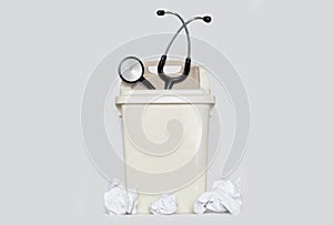 Stethoscope in Plastic Trash Can and Paper Waste. Shows Quit the Medical Job, Disappoint and Give up Doctor Profession