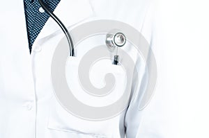 Stethoscope in a pocket of a doctor`s white lab coat photo