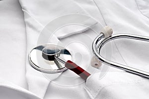 A stethoscope in a pocket of a lab coat