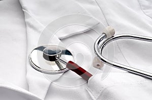 A stethoscope in a pocket of a white lab coat