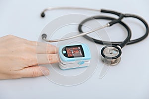Stethoscope, pulse oximeter and thermometer gun on white background. Phonendoscope. Infrared isometric thermometer gun