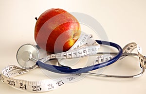 Stethoscope with red apples on a white background
