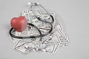 Stethoscope and red heart on American Dollars