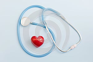 Stethoscope and red heart blue background