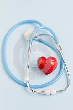 Stethoscope and red heart blue background