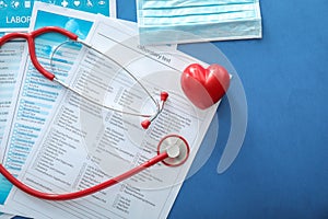 Stethoscope with red heart and lists of laboratory tests on color background. Health concept