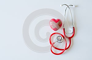 Stethoscope and red heart with notepad on white blackground,Hands Check,Healthcare and medical concept