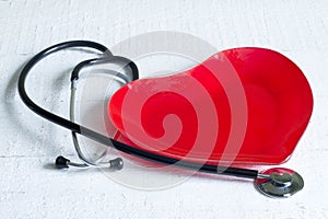 Stethoscope and a red heart plate diet concept