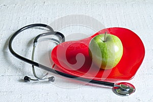 Stethoscope and a red heart plate diet concept