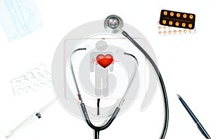 Stethoscope and red heart. Doctor table with medical items