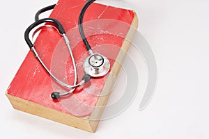 Stethoscope on red old book