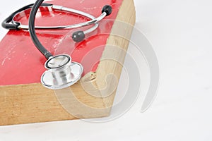 Stethoscope on red old book