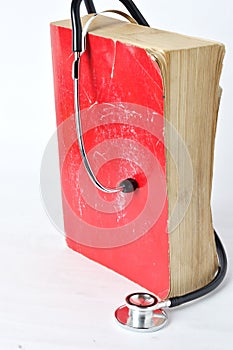 Stethoscope on red old book