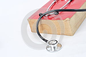Stethoscope on red old book