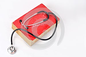 Stethoscope on red old book