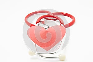 Stethoscope and red velvet heart lie on each other on white uniform background. Photo for use in cardiology, heart health, heart d