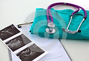 A stethoscope shaping a heart and a clipboard on a