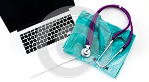 A stethoscope shaping a heart and a clipboard on a medical uniform, closeup