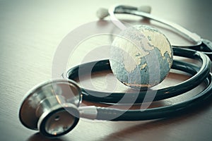 Stethoscope and texture globe with digital tablet