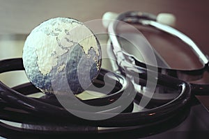 Stethoscope and texture globe with digital tablet