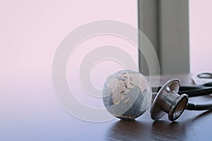 Stethoscope and texture globe with digital tablet