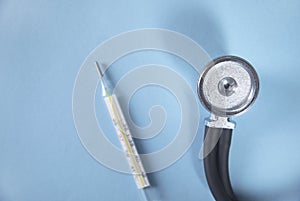 Stethoscope and thermometer on table