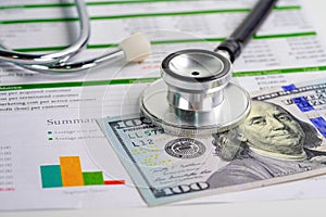 Stethoscope and US dollar banknote money. Finance, Account, Statistics, Investment, Analytic research data economy and Business