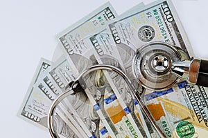 Stethoscope in US dollar bills on medical costs healthcare payment of paid medicine