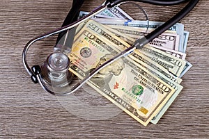 Stethoscope on US dollar bills. Medical services, health insurance cost concept