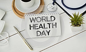 Stethoscope, white paper, with wooden board and inscription World Health Day on wooden background