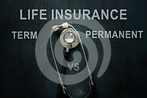 Stethoscope and words on the desk Life insurance term vs permanent.