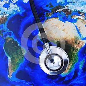 Stethoscope on a world map (furnished by NASA)