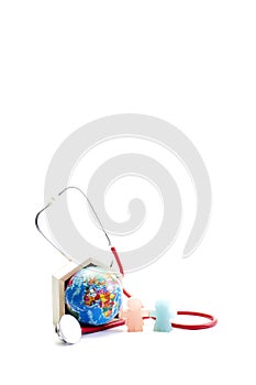 Stethoscope wrapped around globe on white