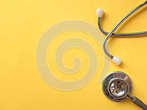Stethoscope on a yellow background.Concept of health care