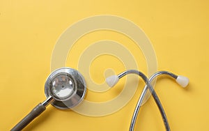 Stethoscope on a yellow background.Concept of health care