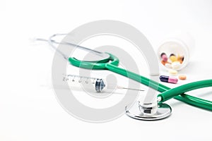 Stethoscopes with syringe and pill - Medical concept