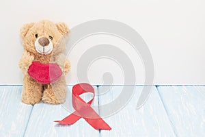 Stetoscope, red heart and bear on blue background with red heart.