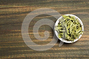 Stevia dried leaves - Stevia rebaudiana. Wood background