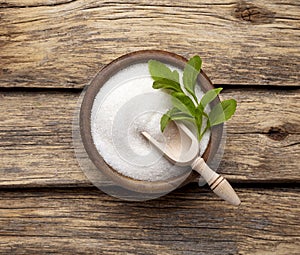 Stevia rebaudiana, sweet leaf sugar substitute isolated in wooden bowl on wooden background