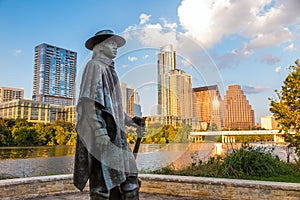 Stevie Ray Vaughan statue in front of downtown Austin and the Co