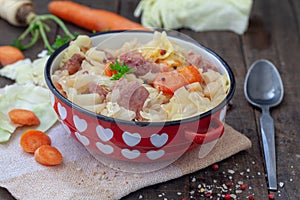 Stew cabbage with pork in red pot