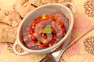 A stew of red beans, meat and corn