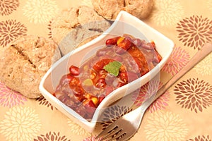 A stew of red beans, meat and corn