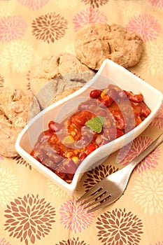 A stew of red beans, meat and corn