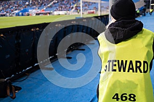 Steward next to the football pitch